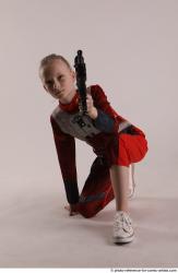 DENISA KNEELING POSE WITH GUN